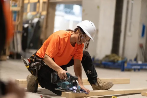 professional carpenter cutting timber on site