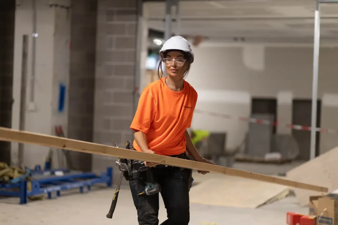 woman electrician working on commercial electrical installation