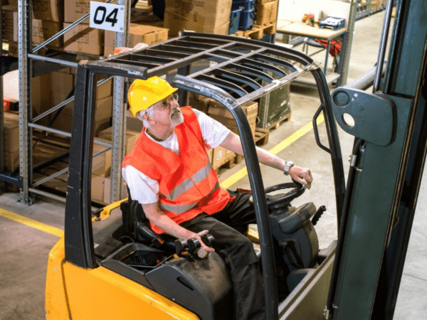 Warehouse employment agency workers picking orders and operating forklifts in a busy warehouse